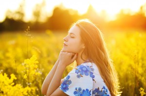 Beautiful girl on the flowers field Beautiful blonde woman in the flowers field on sunset  Healthy Lifestyle Soft focus
